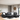Rocket black leather reversible sectional with drop-down table and storage ottoman.
